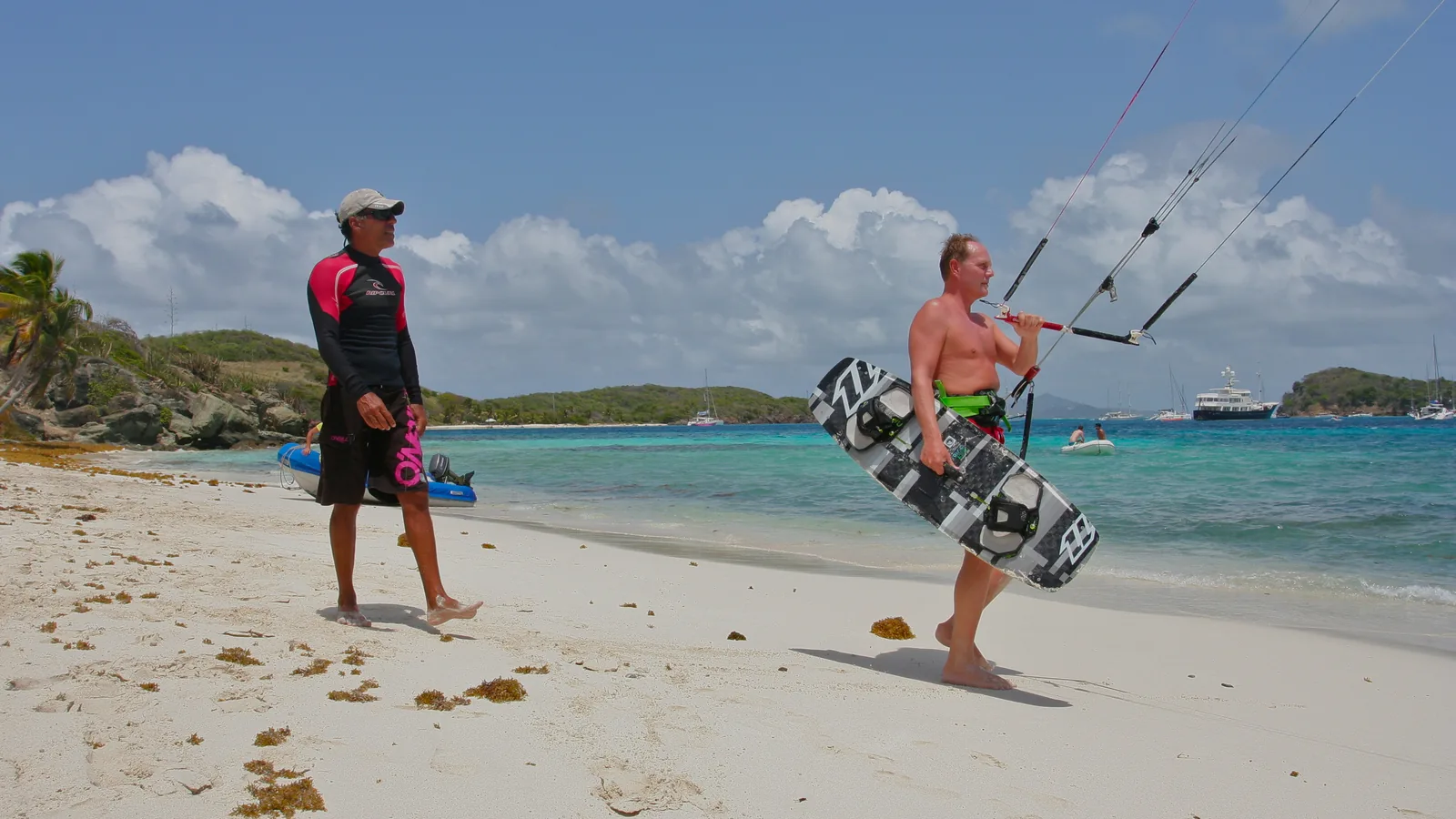 Kitesurf instructor coaching a guest on the beach, Tobago Cays, St Vincent and the Grenadines