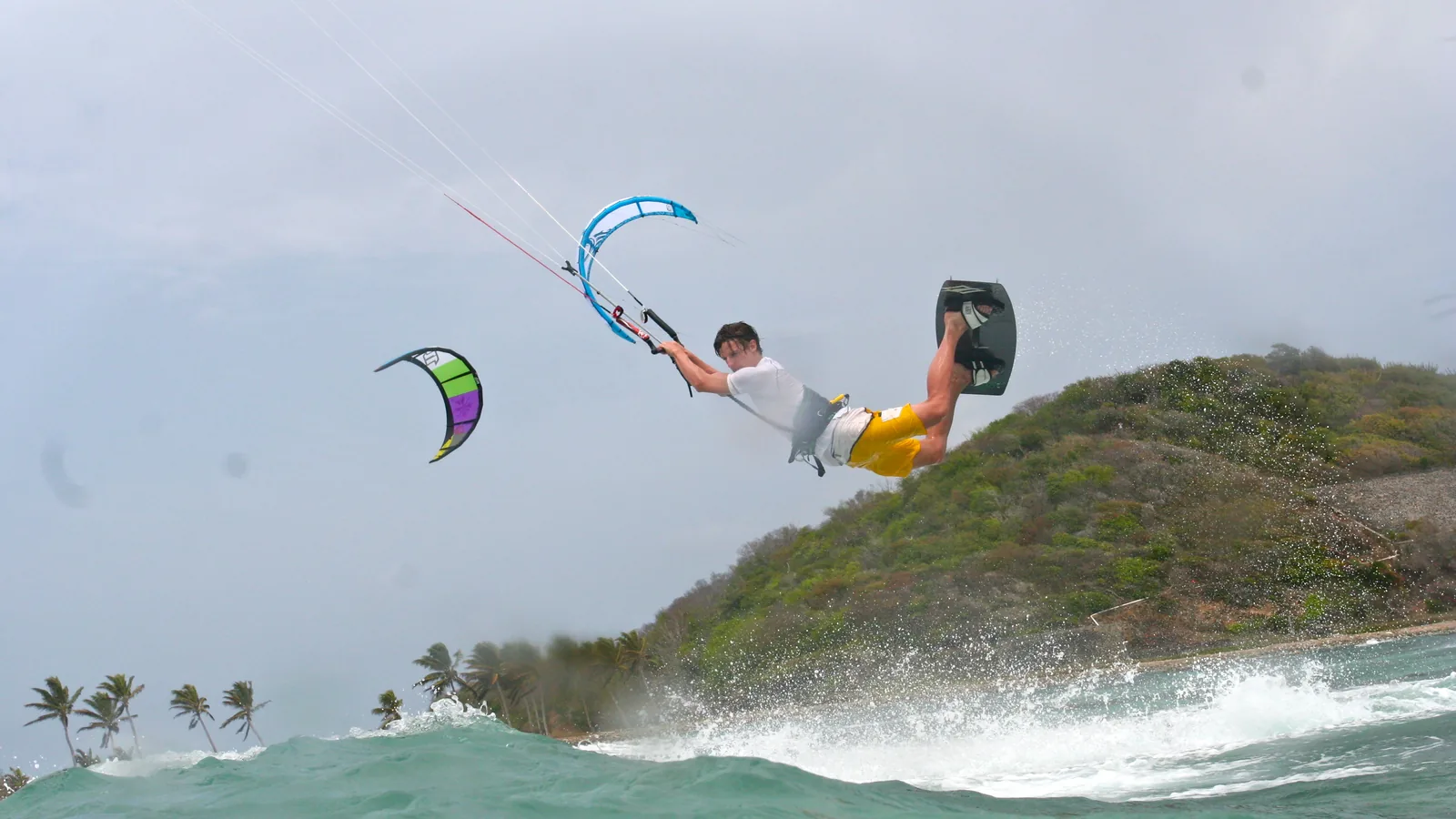 Kitesurfer jumping off Mayreau, Salt Whistle Bay, St Vincent and the Grenadines