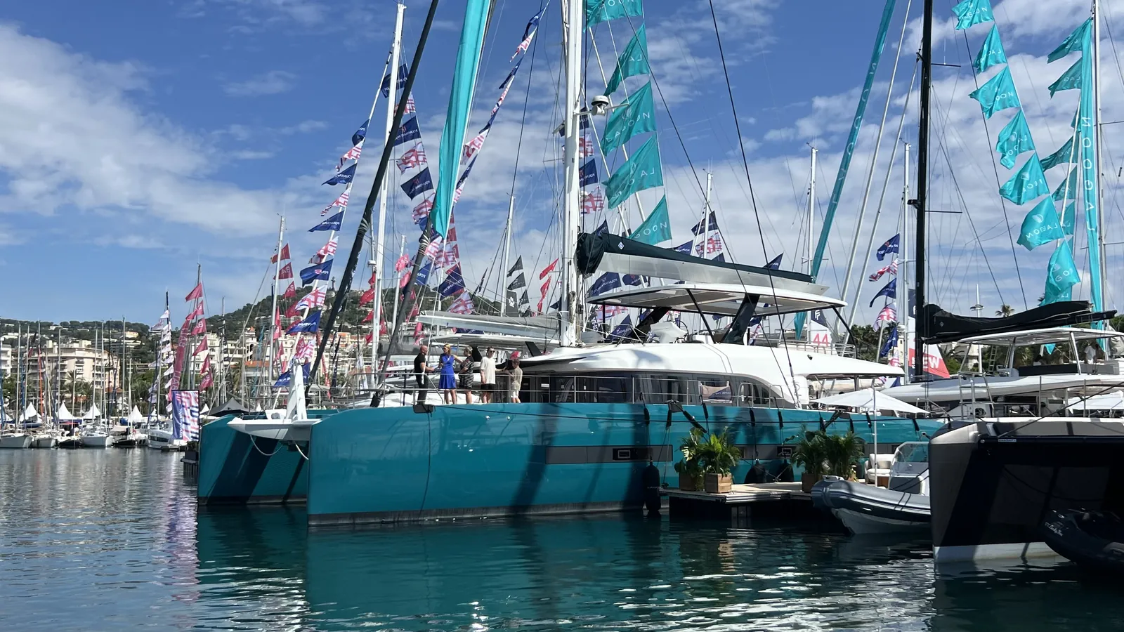 Catamarans berthed among the festival flags at Port Canto, Cannes