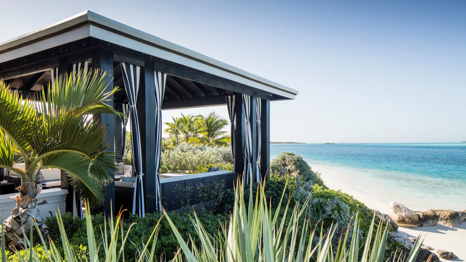 Beach cabana at Villa West Sands overlooking white sand and turquoise water, the Exumas