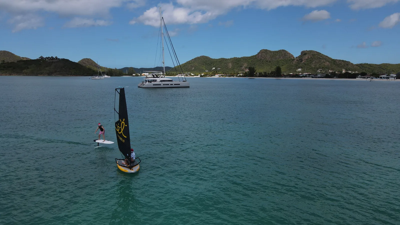 Yacht at anchor in Antigua with dinghy sailing and electric foiling, Lagoon Seventy7